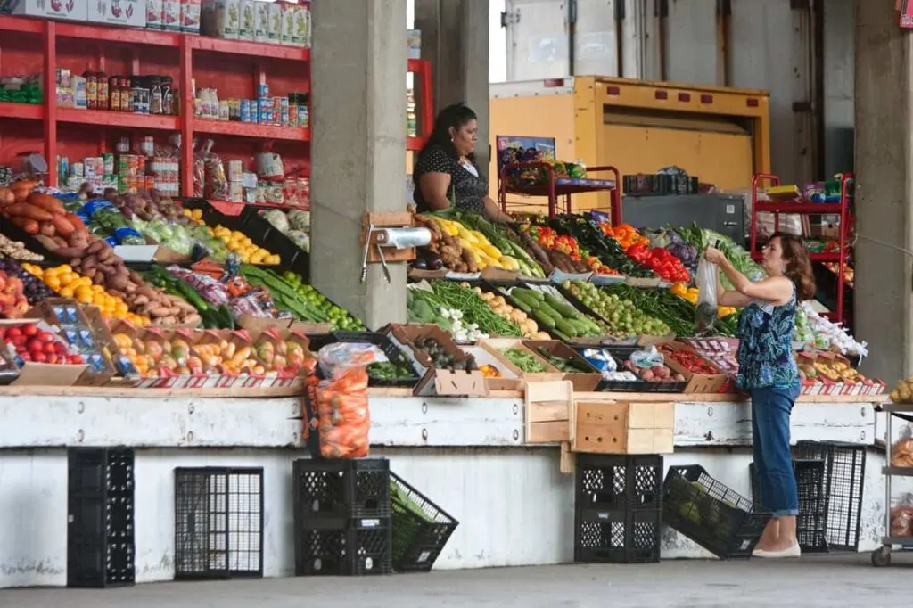 Woman Buys Veggies at Atlanta Farmers Market